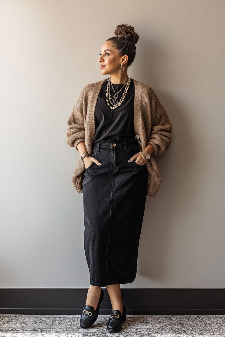 Woman in a modern styled outfit with cardigan and denim skirt